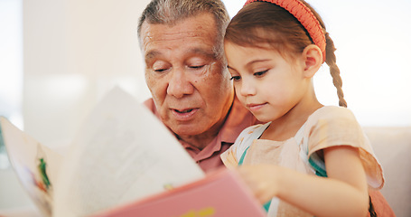 Image showing Grandparent, kid and reading book with smile, home and child development, grandchild and couch. Man, lounge or bonding together for relationship, family and retired with girl, house and happy