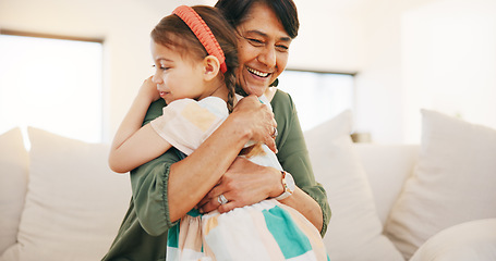 Image showing Grandmother, child and hug on sofa in living room for love, care and bond for relationship. Senior woman, little girl and smile in happiness for memory, moment or support while babysitting at home