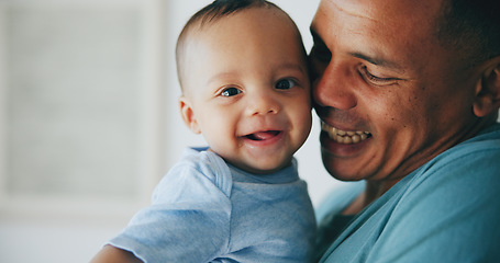 Image showing Happy, love and father hug baby with a smile, support or security in their home together. Family, newborn and face of playful infant with dad in a house for embrace, moment or playing games with care