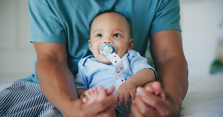 Image showing Family, love and father with baby on a bed for bond, comfort and playing in their home together. Support, care and parent with curious infant son in a bedroom for learning, hug or security in a house