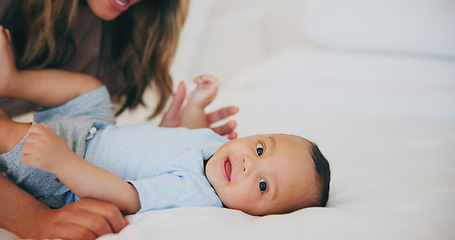 Image showing Hands, love and portrait of baby in bed with mother at home, play and family bonding together. Face of child, mom and closeup of infant in bedroom, security and care of toddler or kid for growth