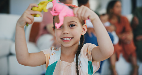 Image showing Girl kid, dinosaur toys and smile for playing, development and relax with game in living room at family house. Child, plastic reptile and happy in lounge and youth for fantasy, learning and home