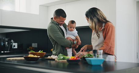 Image showing Happy, couple and baby cooking vegetables in kitchen for nutrition food, child development or parent connection. Man, woman and boy in home for meal prepare or health wellness, ingredients for dinner