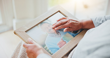 Image showing Senior woman, grief and picture of husband on lap, hands and sad of love loss in retirement. Elderly person, alone and dear memory of beloved with anxiety, mental health and lonely bereaved in house