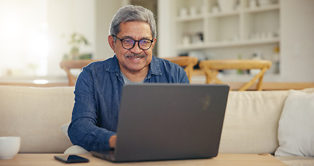 Image showing Elderly, man and smile for laptop living room on sofa for typing, email or message for communication. Senior person, looking at screen and glasses with technology, internet or web for work from home