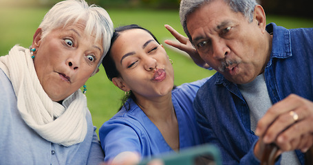 Image showing Selfie, peace sign or funny face with a nurse and old couple outdoor in an assisted living garden together. Comedy, support or wellness with a senior man, woman and young caregiver in the backyard