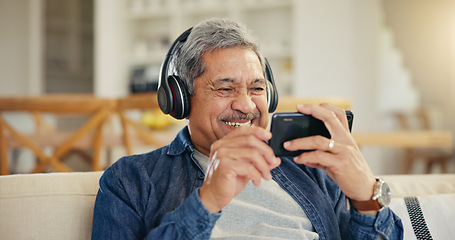 Image showing Senior, man and headphone with phone in living room for streaming, entertainment and mobile app. Elderly person, smile and retirement with technology with laugh for funny video, movie or film in home