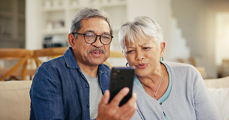 Image showing Senior couple, smartphone and video call in living room sofa, conversation and joyful. Grandparents, technology and communication with family, man and woman in retirement, happy and connection