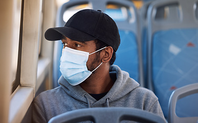 Image showing Man, mask or travel in bus in city, cold protection or window view for thinking on journey. Young person, cap or medical cover on mouth for flu virus, transport safety or healthcare rules on vehicle