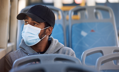 Image showing Man, mask or thinking in bus in city, cold protection or window view on trip for wellness. Young person, cap or medical cover on mouth for flu virus, transport safety or healthcare rules on vehicle