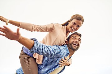 Image showing Couple, piggy back and smile for peace, outdoors and vacation or holiday, date and bonding for love. Happy people, play and freedom on trip, airplane and connection in marriage, support and trust