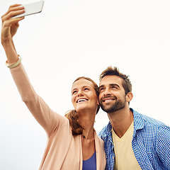 Image showing Couple, phone and selfie on holiday, smile and outdoors on adventure, love and memories for social media. Happy people, smartphone and bonding or technology, travel and vacation or profile picture