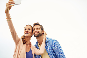 Image showing Couple, phone and selfie on vacation, smile and outdoors on adventure, love and memories for social media. Happy people, smartphone and bonding or technology, travel and holiday or profile picture