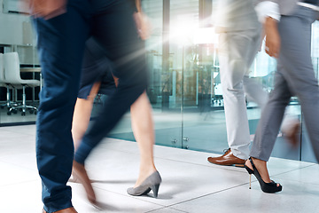 Image showing Business people, travel or legs walking in office in commute to action together for work or job. Motion, shoes closeup or group of workers in lobby of workplace with blur or suit or corporate staff
