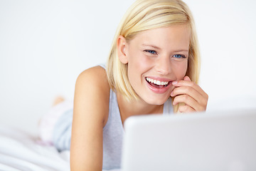 Image showing Happy, laptop and woman on bed for watching movie, online shopping and internet blog in bedroom. Relax, smile and person on computer for streaming subscription, videos and series on weekend at home