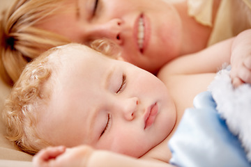 Image showing Sleeping, mom and calm baby in bed together with peace, happiness and love for infant in morning nap. Mother, cuddle and sleep with child in closeup and rest with a smile in bedroom or family home