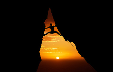 Image showing Mountain, sunset and hiking with the silhouette of a man climbing a cliff or rock outdoor in nature. Sun, horizon and sky with a climber outside for exercise, workout and training in the evening