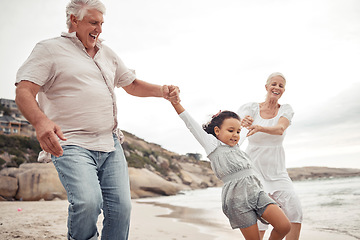 Image showing Senior family with kid at the beach for love, support and child development or outdoor wellness. Excited grandparents or people teaching girl to jump, walking near the sea water with healthy energy