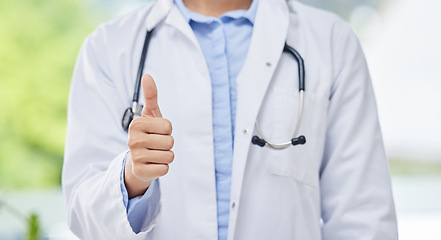 Image showing Doctor, thumbs up and hand of a medical employee, thank you healthcare gesture against blurred background. Hands of a expert surgeon with stethoscope in yes sign or agreement for health success