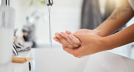 Image showing Water, soap and clean woman hands in bathroom for covid 19, corona virus or healthcare safety. Cleaning and wellness background with a person washing bacteria in foam liquid for skincare or hygiene
