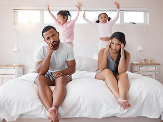 Image showing Autism, headache and children with tired parents in their bedroom at home with adhd kids jumping on the bed. Family, noise and stress with a sad man and woman looking exhausted with no energy