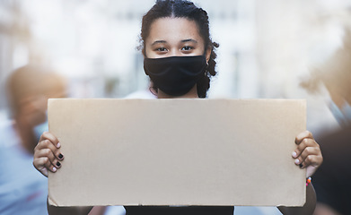 Image showing Activism, protest and girl with a poster with copy space in a street with face mask during pandemic. Portrait of human rights activist protesting with a empty sign for equality or justice in the city