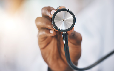 Image showing Stethoscope, healthcare and medicine with the hand of a doctor listening to a heartbeat or breathing in a hospital. Medical, insurance and consulting with a medical or health professional in a clinic