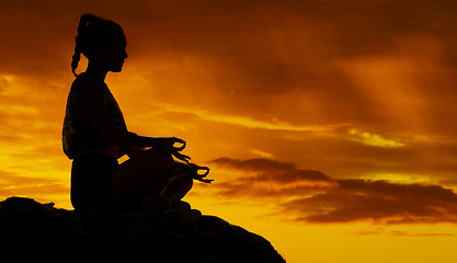 Image showing Yoga, mountain and meditation with silhouette of woman at sunset for peace, mind and zen in nature. Freedom, landscape and energy with girl relax after hiking for health, wellness and motivation