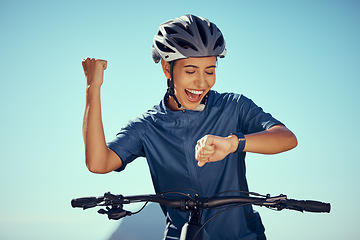 Image showing Cycling watch time, happy woman and success, winner achievement and progress for triathlon competition race. Professional bicycle athlete, fitness smartwatch and fist celebration for sports training