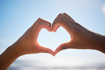 Image showing Heart sign, beach hands and blue sky on vacation by the sea, happy on international holiday in Miami and love for summer travel in nature. Person with emoji for happiness by the ocean in spring