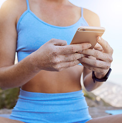 Image showing Woman hands, fitness app and phone typing outdoor in workout videos, exercise tutorial and workout music playlist. Closeup yoga girl reading social media, mobile notification and online virtual coach