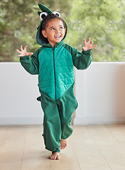 Image showing Child, smile and excited in halloween dinosaur costume at home playing role and having fun at party. Happy kid being playful with fantasy character in living room mimic animal actions ready to roar.