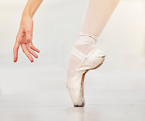 Image showing Closeup of dancer foot on floor, ballet shoe and hand, show posture and balance at dance class. Zoom of woman dancing in studio to practice or stage, during profession performance or recital