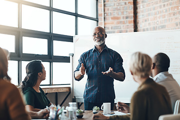 Image showing Senior business man doing presentation, planning and talking in a meeting, seminar or training workshop in a boardroom. Manager sharing ideas, teaching and coaching new employees during conference