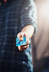 Image showing Male customer holding his credit card in his hand to complete and pay for his shopping purchase. Guy choosing an electronic finance payment method for paying. Retail shop client ready to spend money