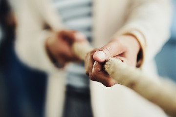 Image showing Teamwork, hands and tug and war while joining forces and pulling a rope for battle against competitors. Closeup of strong businessperson fighting for power, leadership and equality rights