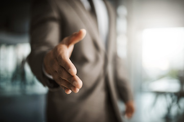 Image showing Closeup of professional executive businessman reaching for handshake to thank you for formal interview meeting. Corporate company manager hiring new employee in leadership development