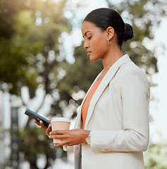 Image showing Business woman texting on phone, booking and ordering city taxi, lift or ride in morning commute to work. Serious and busy professional with coffee checking, reading or browsing social media