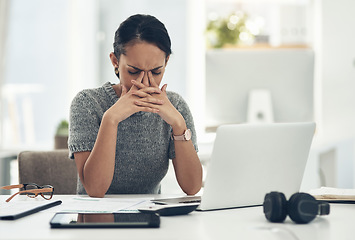 Image showing Stress, anxiety and worry with a businesswoman feeling negative, overworked and overwhelmed while suffering from a headache or migraine. Young female working on a laptop at her desk in the office