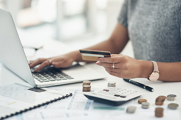 Image showing Budget with technology for online shopping and working indoors. Closeup of financial advisor counting money on laptop in the office. Businesswoman holding card, coins and calculator on table.