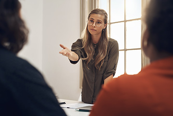 Image showing Young, upset and professional businesswoman in a meeting with two workers having an argument. Group, team or people training and discussing at the office or leader blaming worker for poor performance