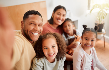 Image showing Happy family taking selfie, having fun, relaxing and bonding in living room at home. Smiling, carefree parents enjoying time with children indoors, being affectionate and together on the weekend