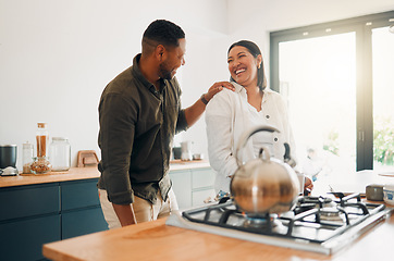 Image showing Joyful and loving couple bonding and having fun while spending time together in the kitchen. Smiling, in love and carefree couple laughing, sharing a romantic moment while enjoying the morning