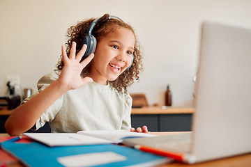 Image showing Online, distance learning child on laptop webcam or video call joining lesson with headphones and hello greeting or goodbye gesture. Little happy student in remote classroom with a teaching notebook