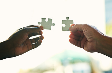 Image showing Unity, synergy and teamwork with a puzzle assembly to find the perfect match or business solution. Employees put jigsaw pieces together for creative thinking team building activity.