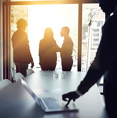 Image showing Planning strategy for a successful and bright future with a team of business people talking in a boardroom meeting with flare. Backlit group of corporate professionals discussing in the office