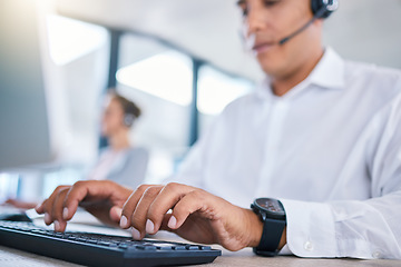 Image showing Call center agent hands or CRM consultant typing client information on PC keyboard while talking on phone with headset. Contact us for customer service or telemarketing hotline support assistance.