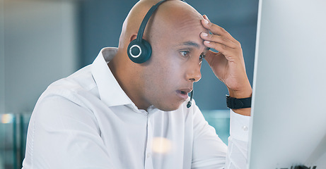 Image showing Shocked, stressed and annoyed call center agent having a bad day at work feeling unhappy and having problems. Tired, bored and frustrated male customer service consultant looking at his computer