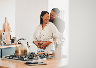 Image showing Loving, happy and hugging couple relaxing in the kitchen at home smiling and laughing together. Carefree, excited and affectionate lovers having fun and enjoying quality time in the house