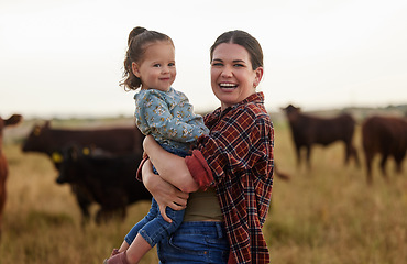 Image showing Family, mother and baby on a farm with cows in the background eating grass, sustainability and agriculture. Happy organic dairy farmer mom with her girl and cattle herd outside in sustainable nature